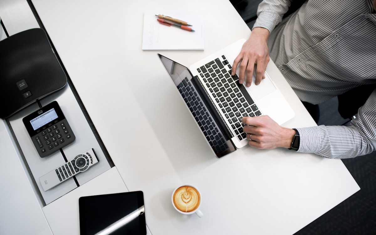 Laptop, tablet and phone connected together on a desk, representing connected business tools